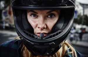 A woman wearing a helmet for safety.