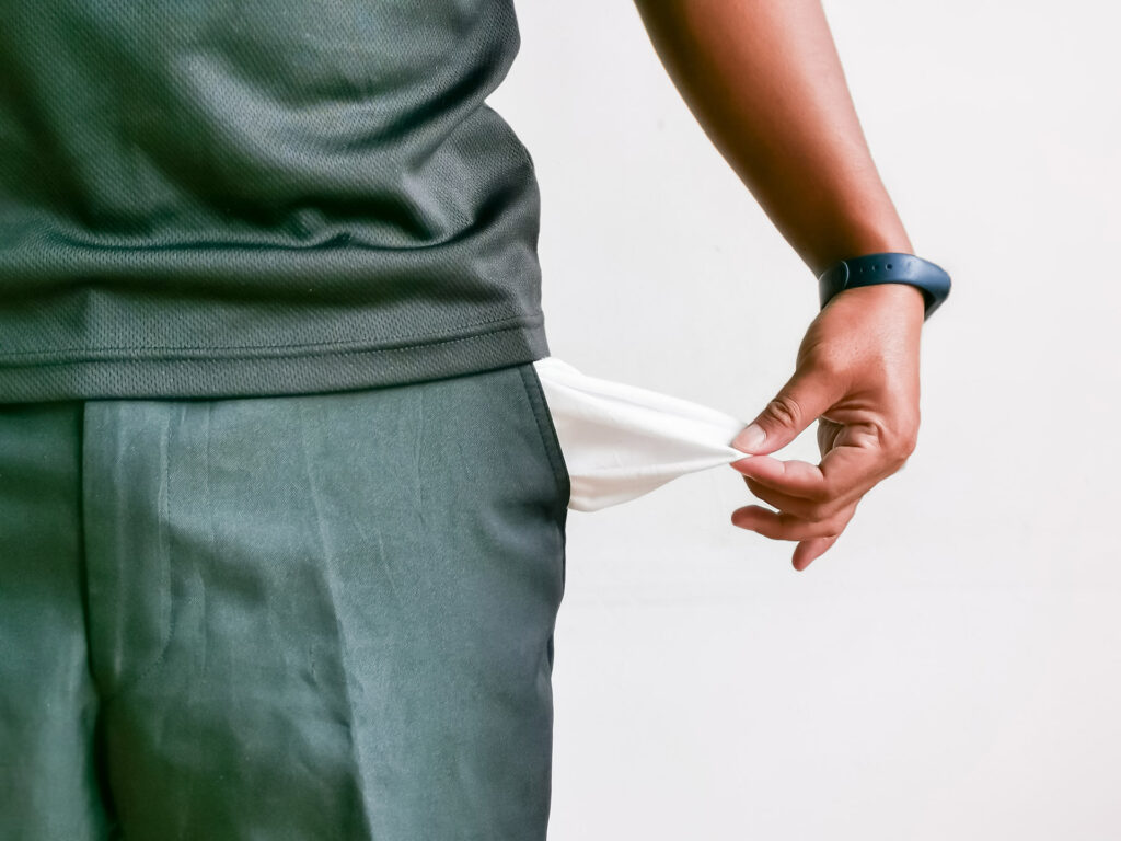 A man's pocket with a watch in it.