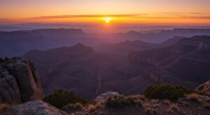 Google Veo Sunrise over the Grand Canyon, with layered rock formations and a winding river visible below, under a clear sky.
